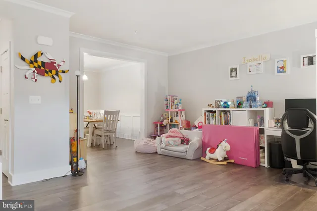 a bedroom with furniture and a wooden floor