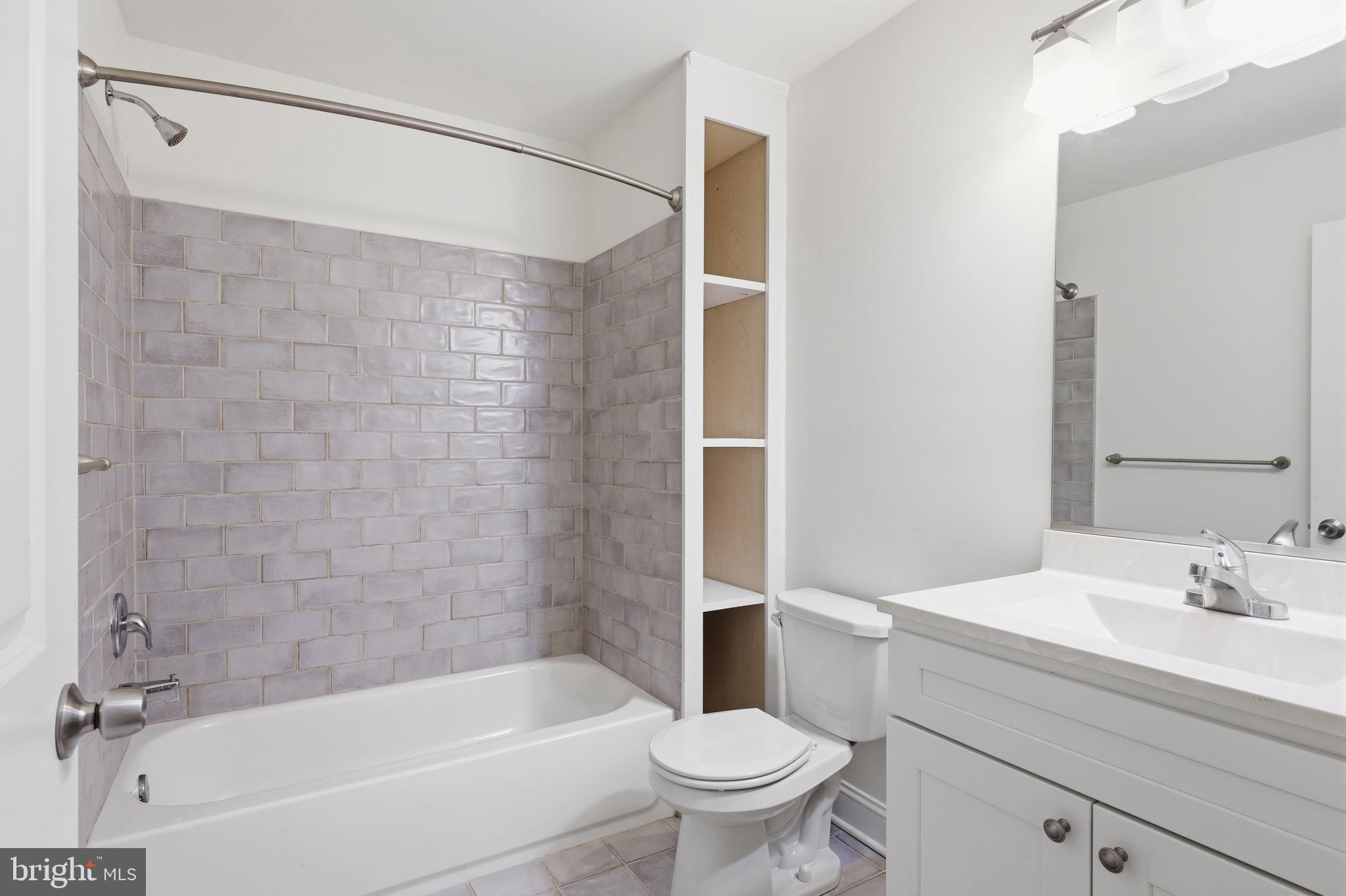 588 Almshouse Road Doylestown, PA 18901 - Photo 24 of 31 a bathroom with a bathtub shower sink vanity and toilet