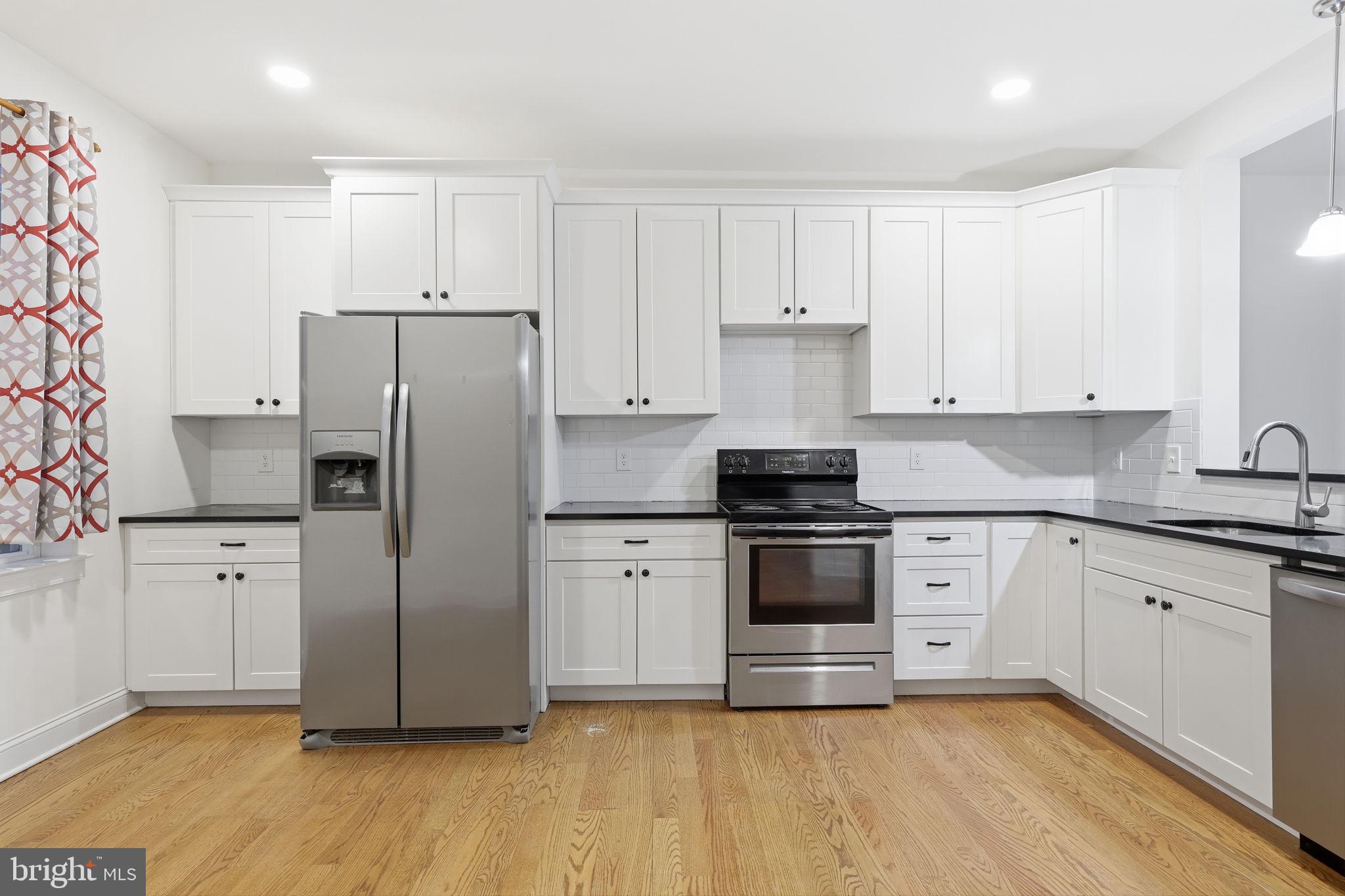 588 Almshouse Road Doylestown, PA 18901 - Photo 7 of 31 a kitchen with stainless steel appliances a refrigerator sink and cabinets