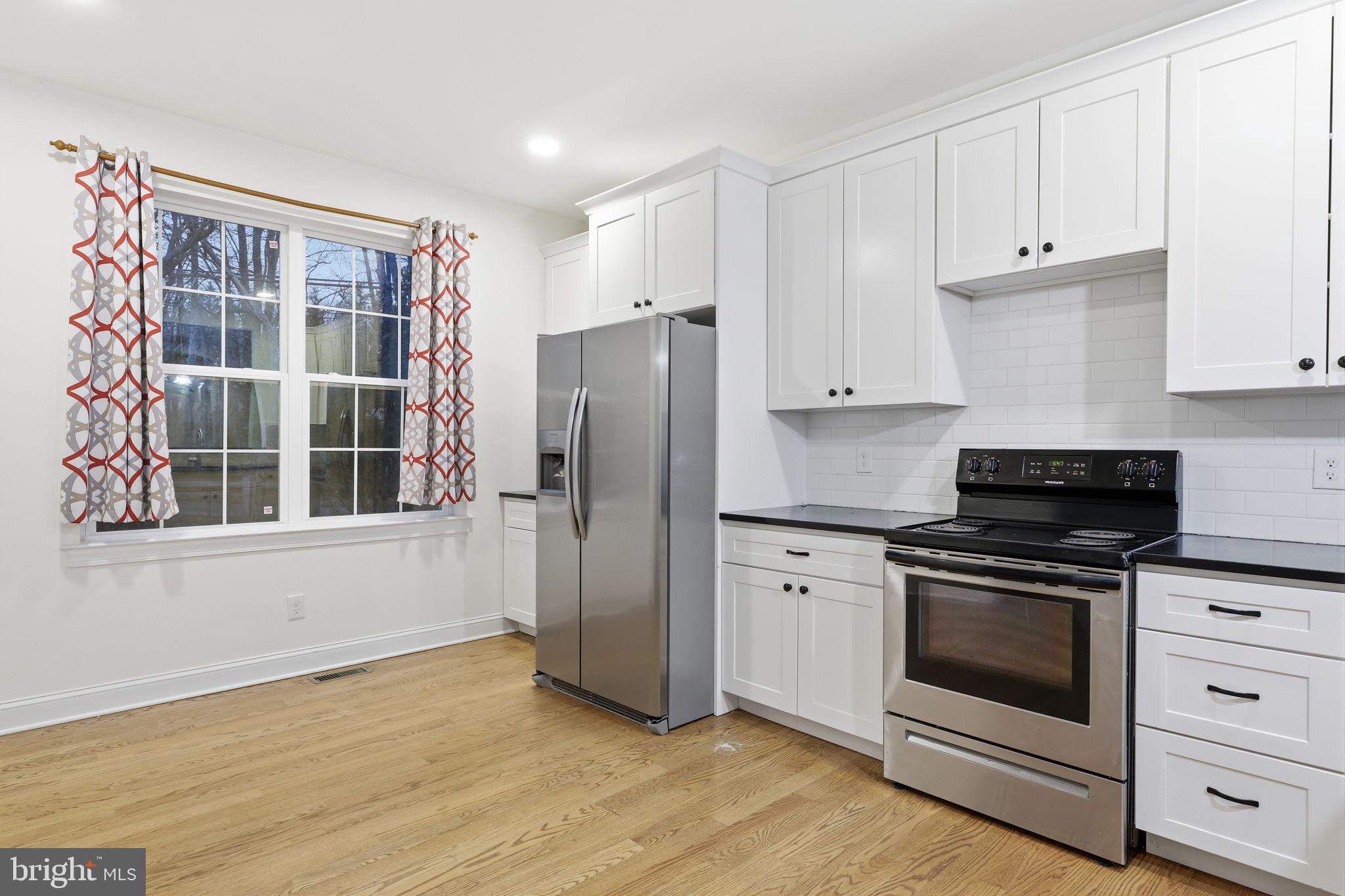 588 Almshouse Road Doylestown, PA 18901 - Photo 9 of 31 a kitchen with a refrigerator stove and white cabinets