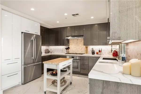 a kitchen with refrigerator and cabinets