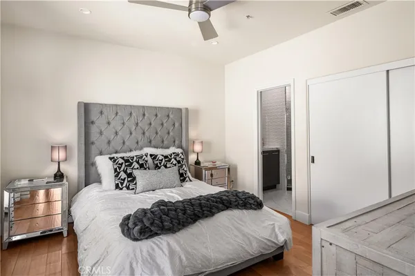 a bedroom with a bed and a night stand