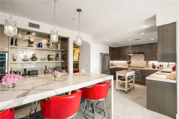 a kitchen with stainless steel appliances kitchen island granite countertop a sink and cabinets