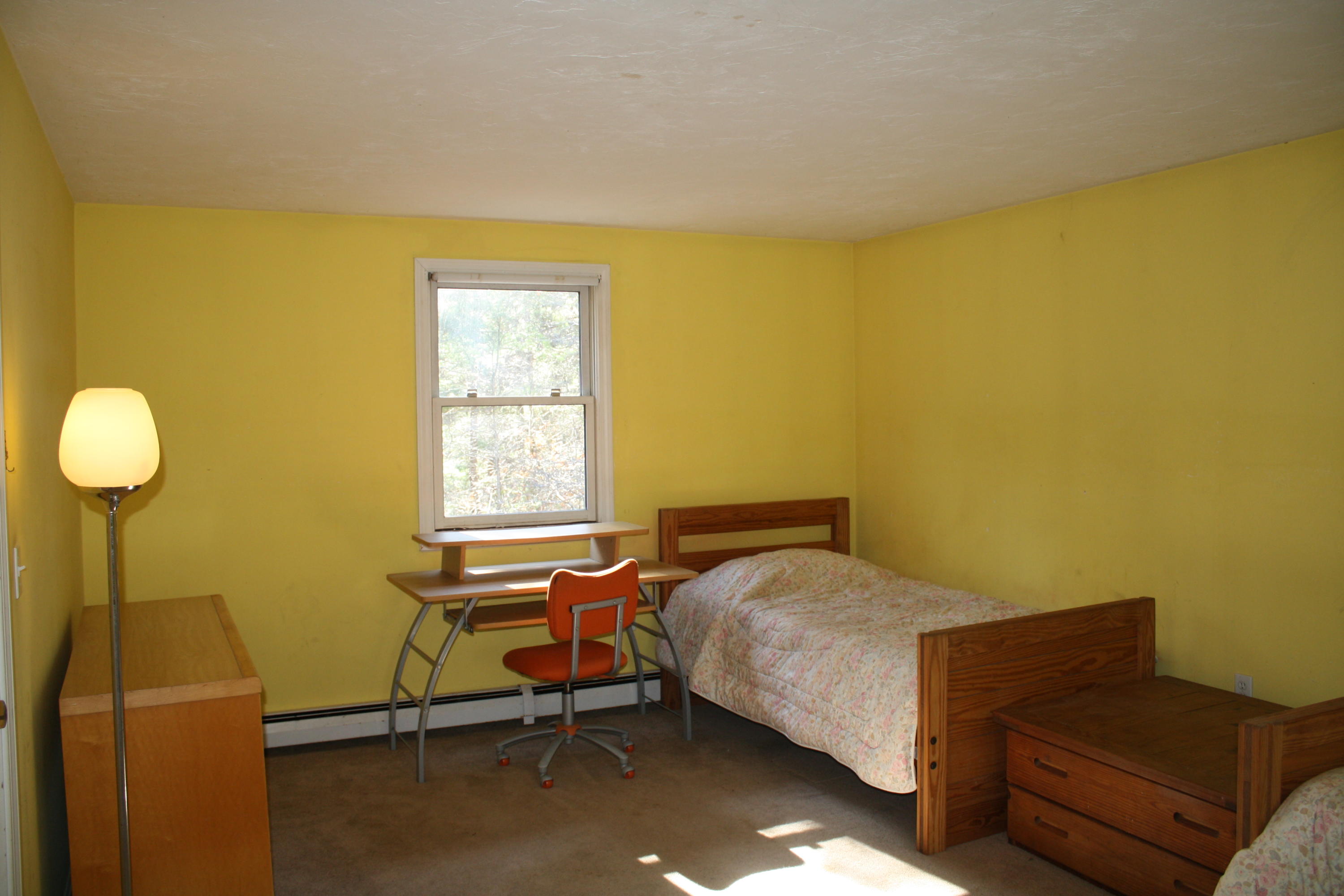 207 Simon Narrows Road Mashpee, MA 02649 - Photo 14 of 18 a bedroom with a bed and chair