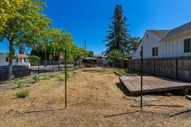 a backyard of a house with table and chairs