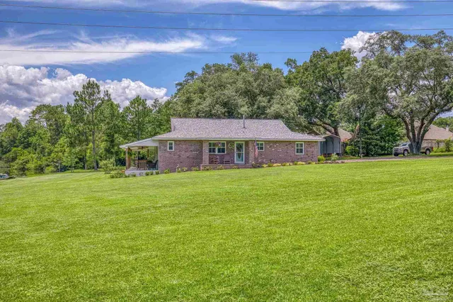 a front view of a house with a garden