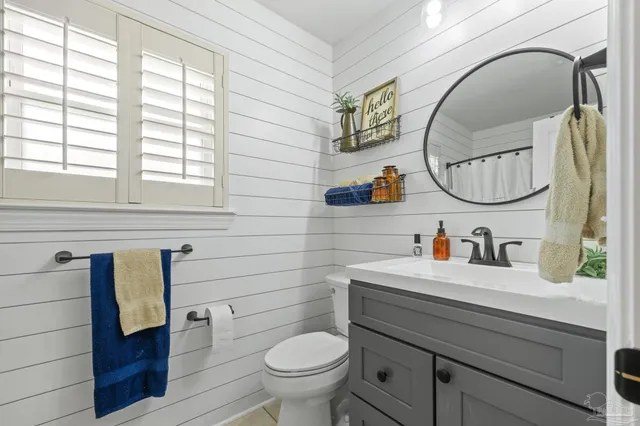 a very nice looking dining room with kitchen island furniture wooden floor and a chandelier