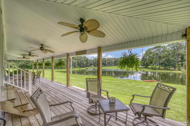 a view of a house with a yard and large trees