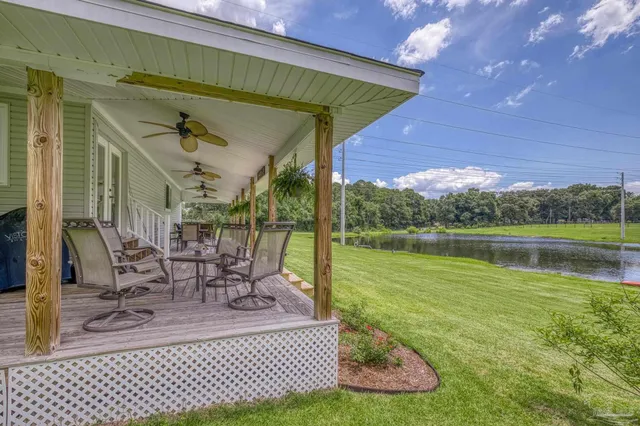 a view of a house with backyard and porch