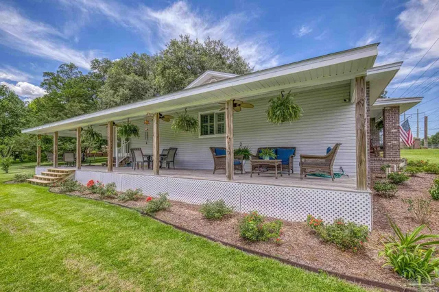 a view of a house with a yard and a garage