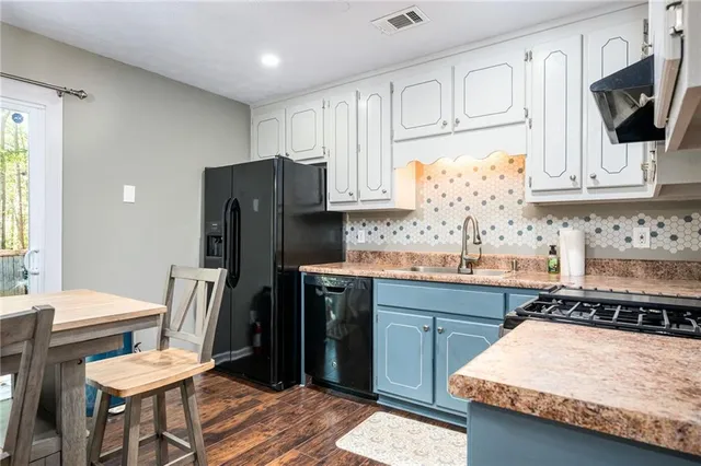 a kitchen with stainless steel appliances granite countertop a refrigerator sink and cabinets
