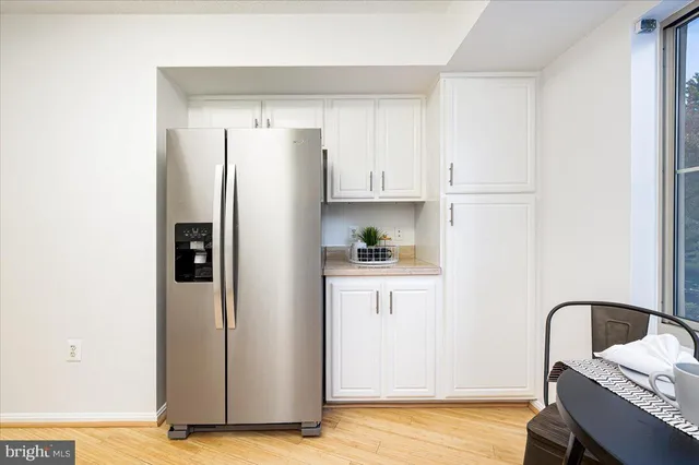 a kitchen with stainless steel appliances a refrigerator sink and cabinets