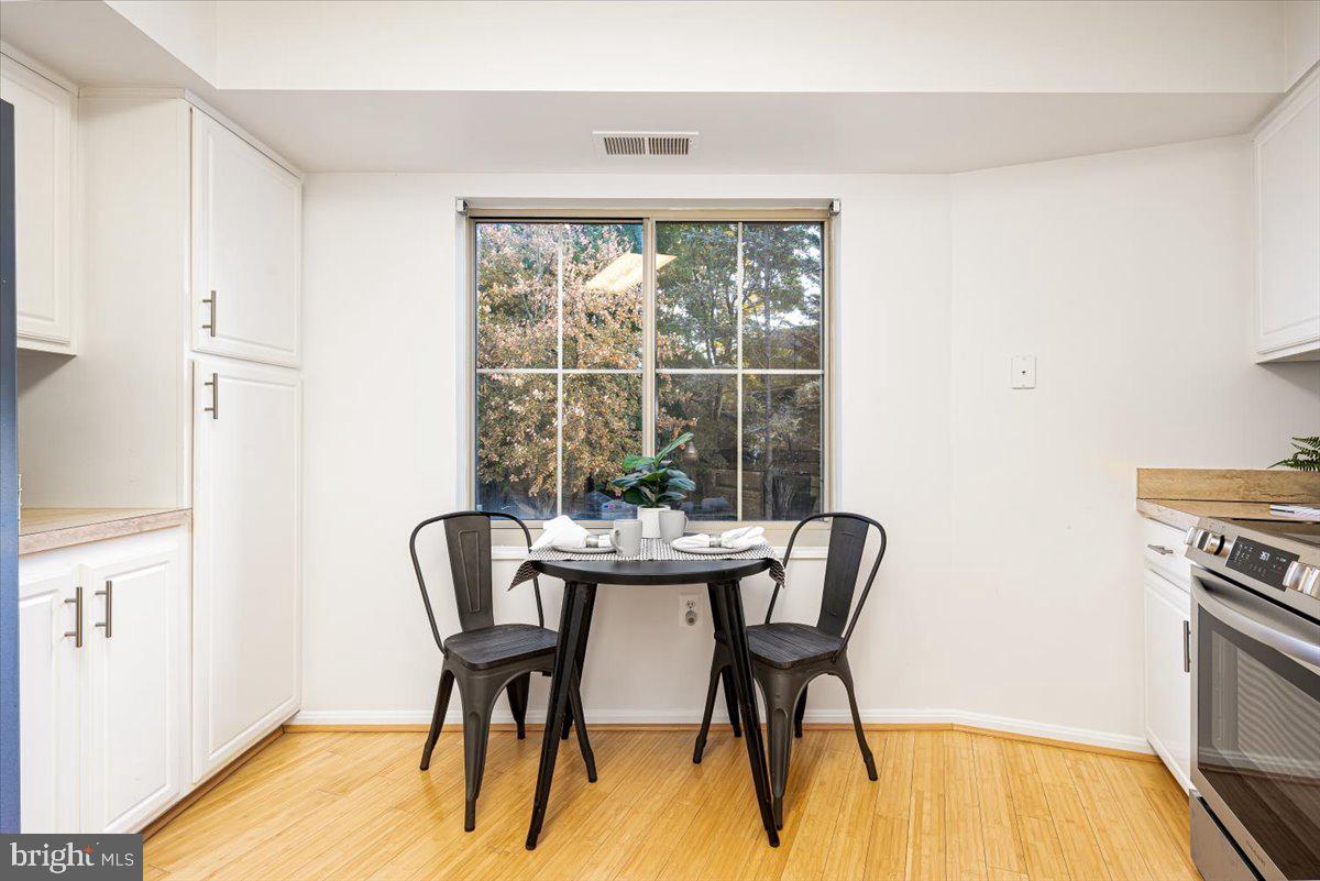 14805 Pennfield Circle, Unit 201 Silver Spring, MD 20906 - Photo 14 of 47 a dining room with furniture and wooden floor