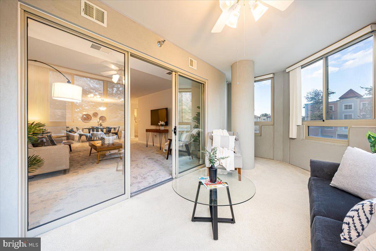 14805 Pennfield Circle, Unit 201 Silver Spring, MD 20906 - Photo 16 of 47 a living room with furniture and a large window