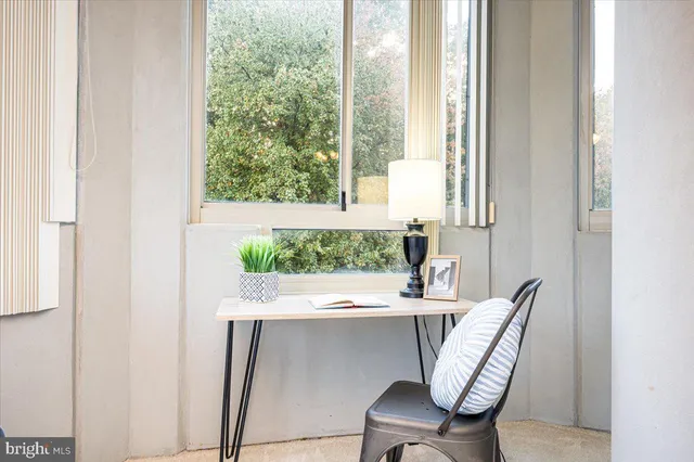 a dining room with furniture and window
