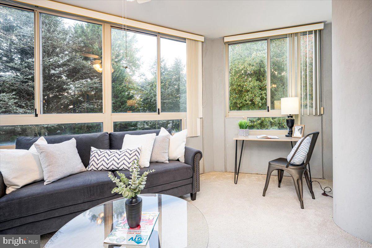14805 Pennfield Circle, Unit 201 Silver Spring, MD 20906 - Photo 19 of 47 a living room with furniture and a large window