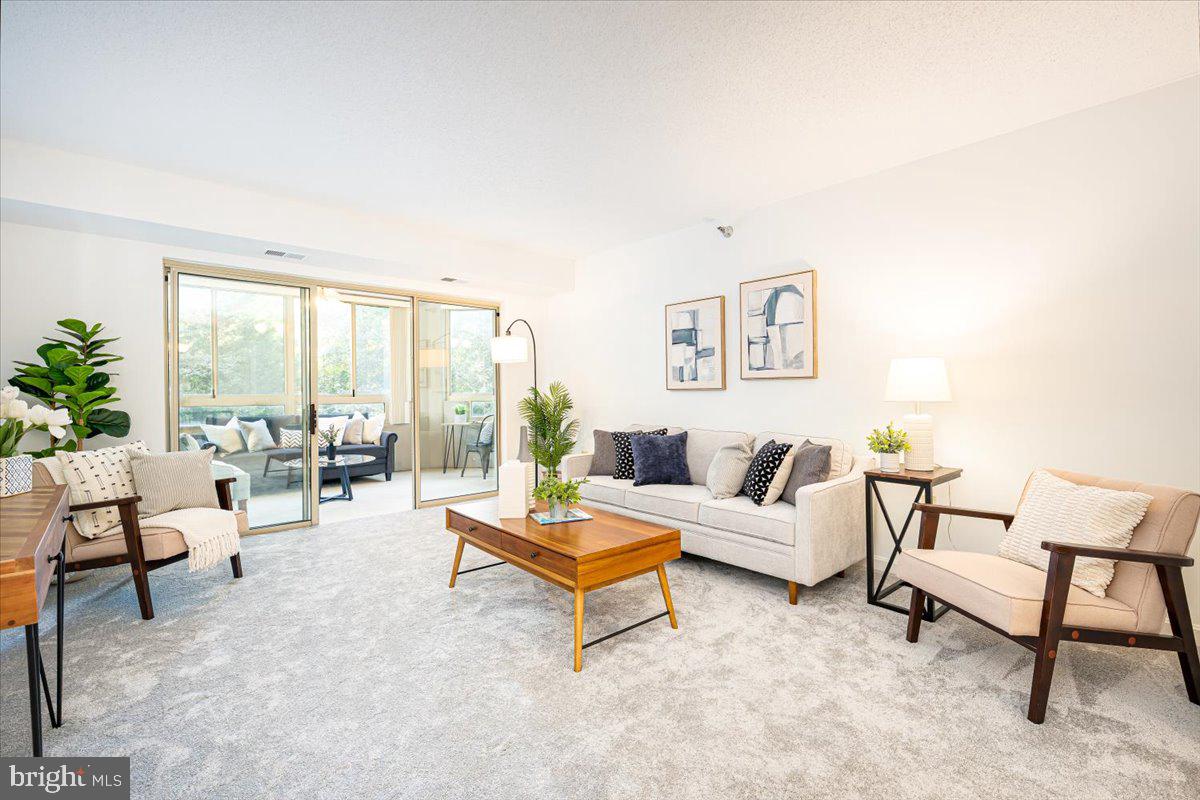 14805 Pennfield Circle, Unit 201 Silver Spring, MD 20906 - Photo 2 of 47 a living room with furniture and a large window