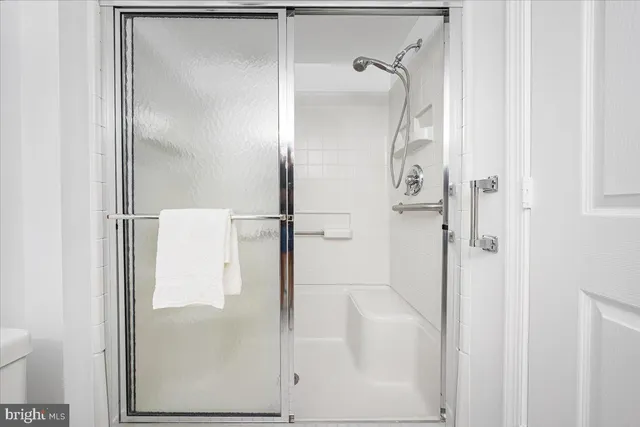 a bathroom with a glass shower door