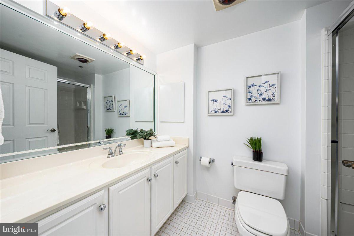 14805 Pennfield Circle, Unit 201 Silver Spring, MD 20906 - Photo 22 of 47 a bathroom with a double vanity sink toilet and a mirror
