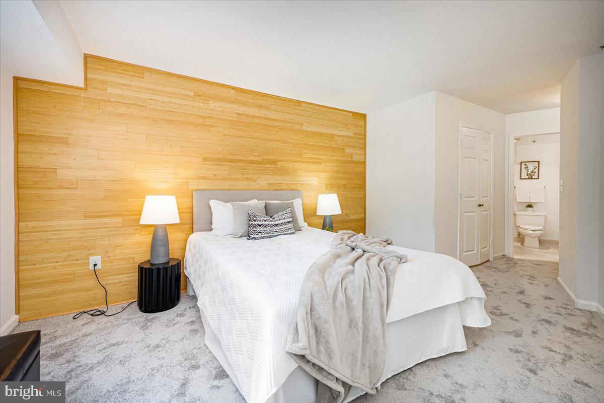 14805 Pennfield Circle, Unit 201 Silver Spring, MD 20906 - Photo 23 of 47 a bedroom with a bed and lamp