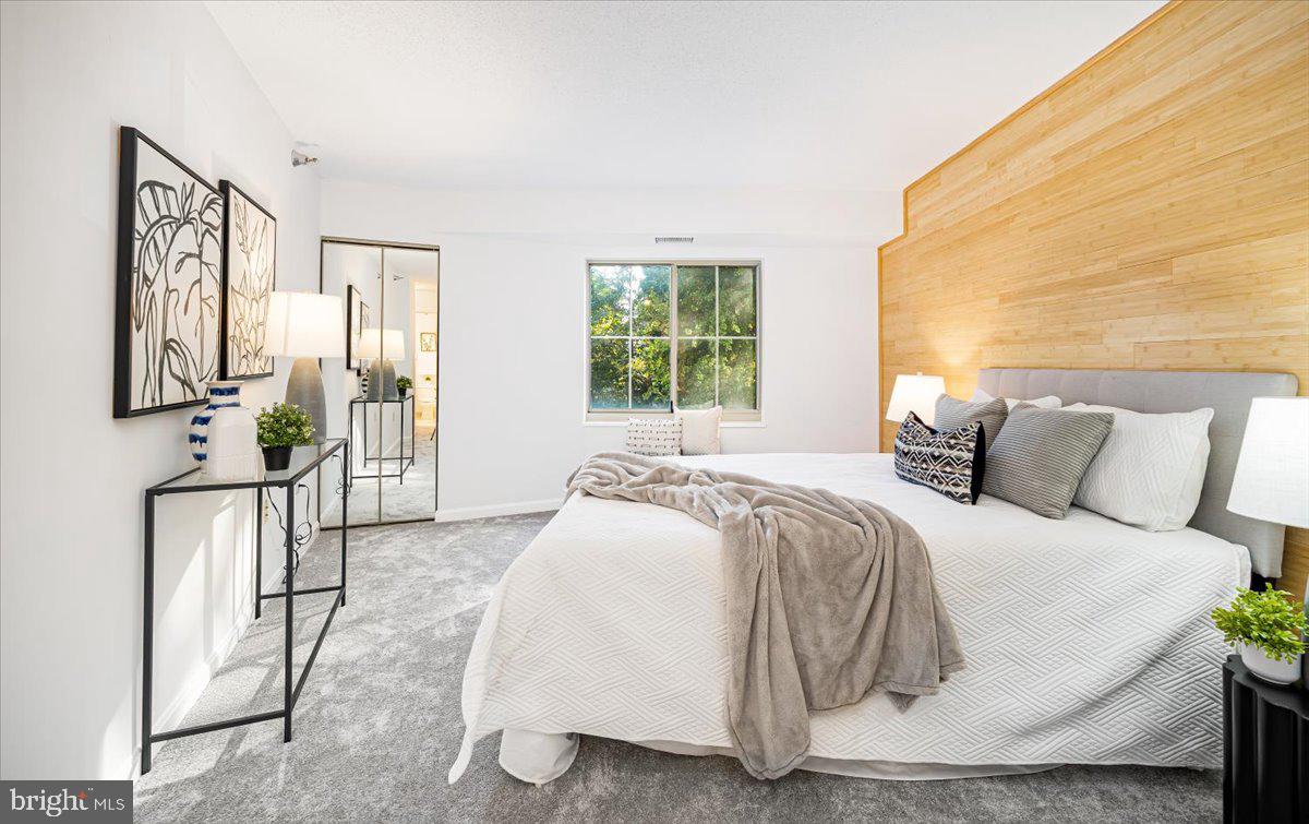 14805 Pennfield Circle, Unit 201 Silver Spring, MD 20906 - Photo 24 of 47 a spacious bedroom with a bed and window
