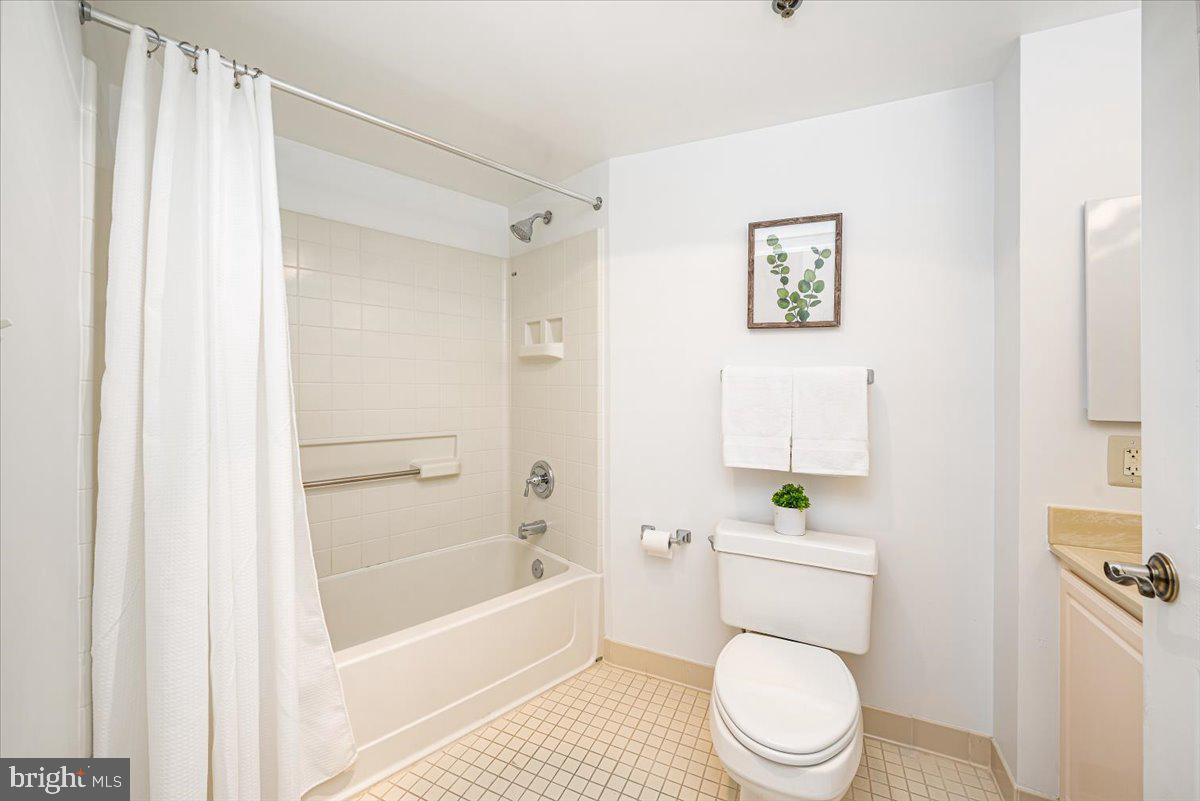14805 Pennfield Circle, Unit 201 Silver Spring, MD 20906 - Photo 26 of 47 a white toilet sitting next to a bathroom sink
