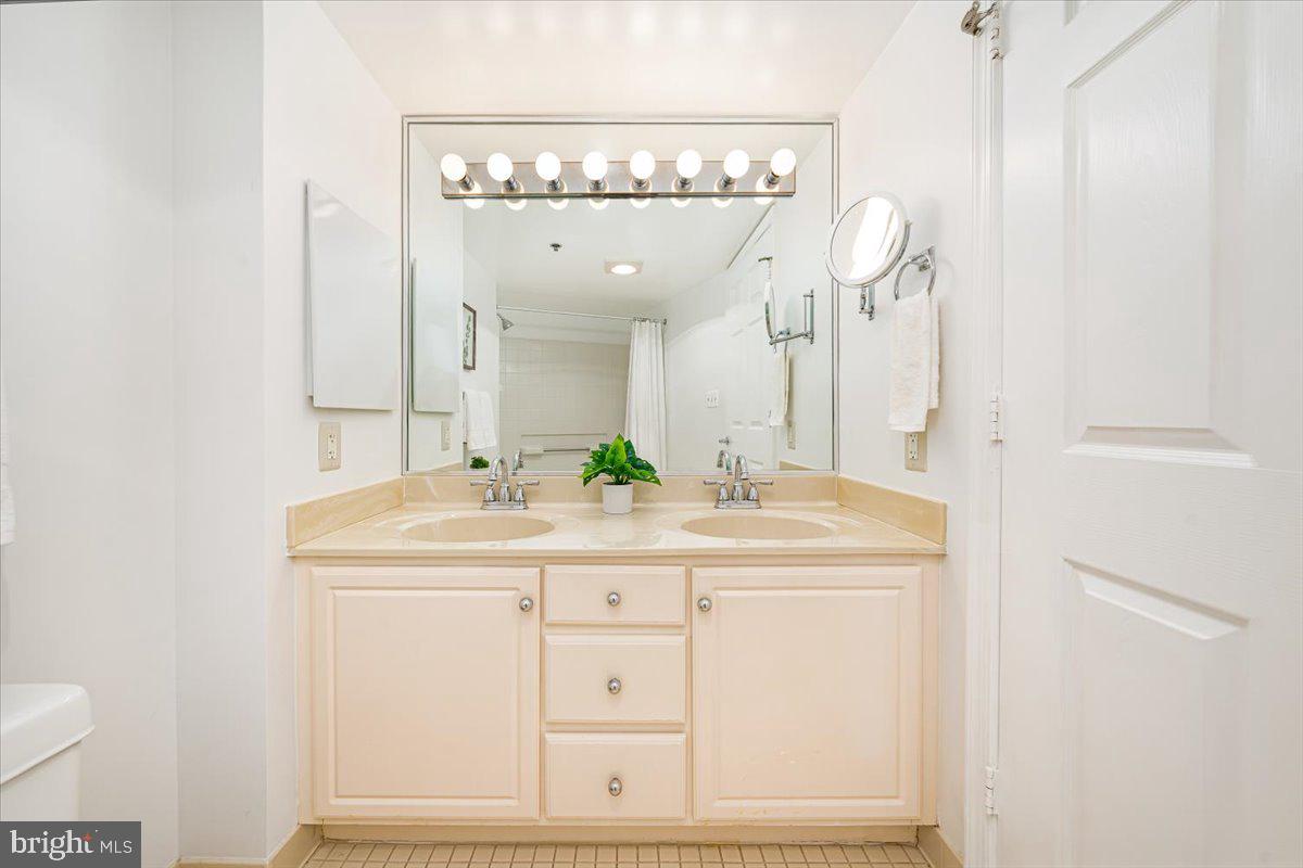 14805 Pennfield Circle, Unit 201 Silver Spring, MD 20906 - Photo 27 of 47 a bathroom with a sink and a mirror