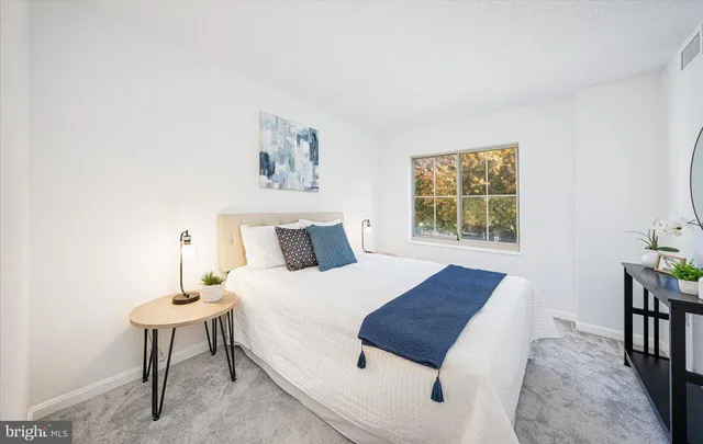 a bedroom with a bed and a table