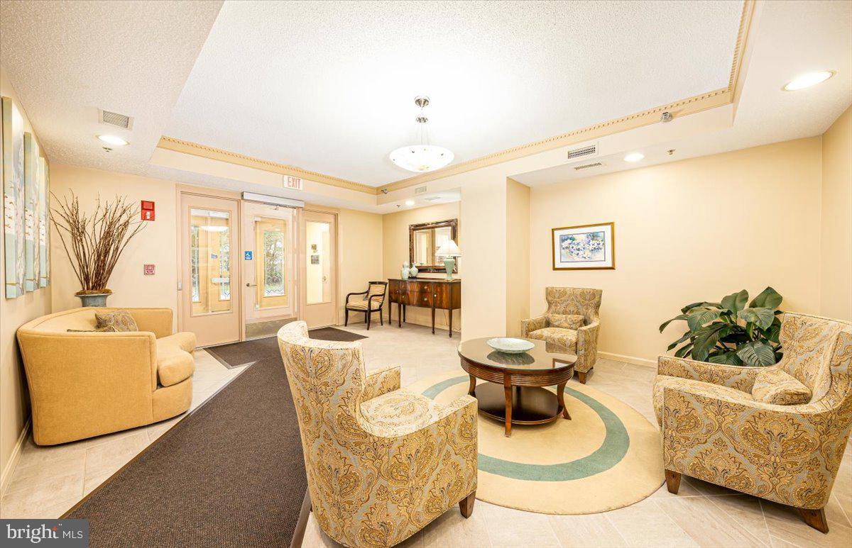 14805 Pennfield Circle, Unit 201 Silver Spring, MD 20906 - Photo 31 of 47 a living room with furniture and a rug