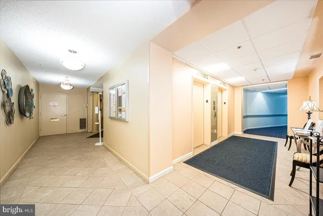 a hallway with a dining table and a stove
