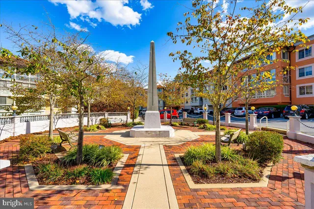 a front view of a house with a yard and potted plants