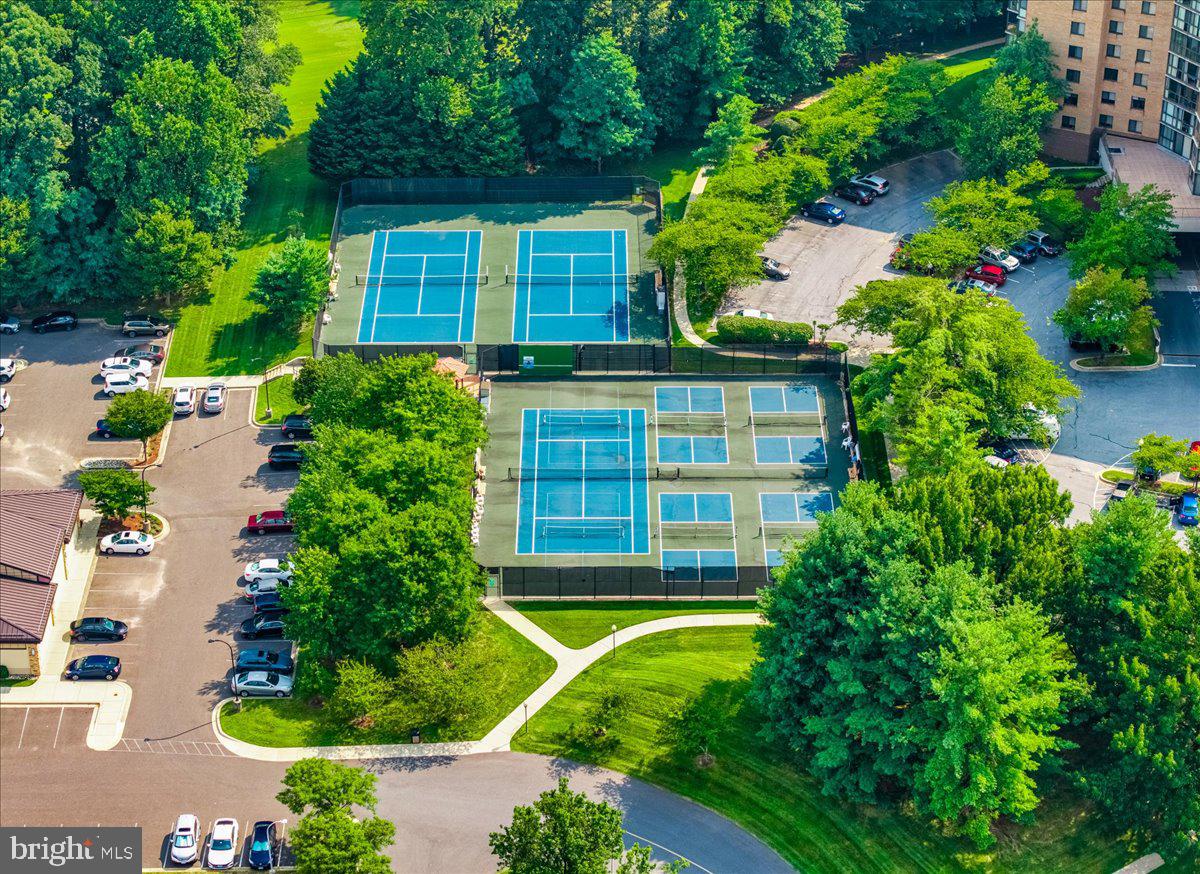 14805 Pennfield Circle, Unit 201 Silver Spring, MD 20906 - Photo 36 of 47 a front view of a house with a yard and potted plants