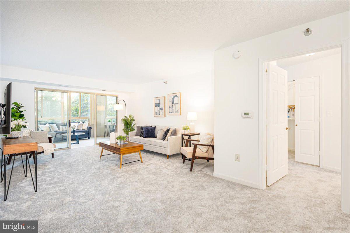 14805 Pennfield Circle, Unit 201 Silver Spring, MD 20906 - Photo 5 of 47 a living room with furniture and a large window