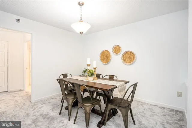a view of a dining room and a table & chairs