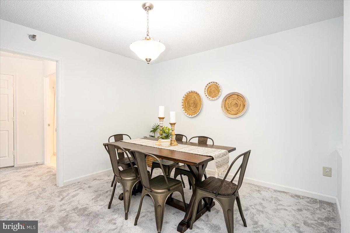 14805 Pennfield Circle, Unit 201 Silver Spring, MD 20906 - Photo 8 of 47 a view of a dining room and a table & chairs
