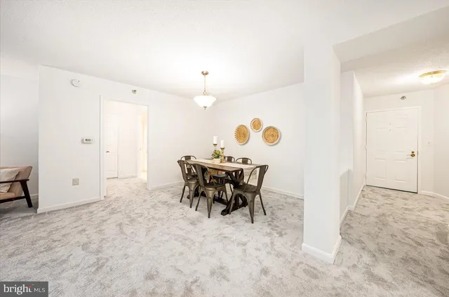 an entryway with table and chairs