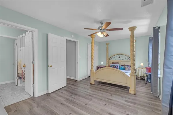 a bedroom with a bed and a chandelier