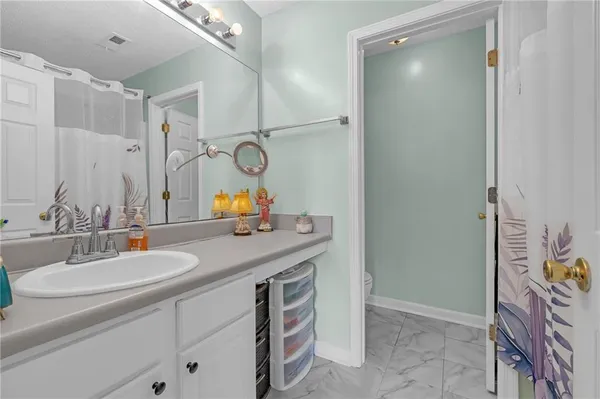 a bathroom with a sink vanity granite and a mirror