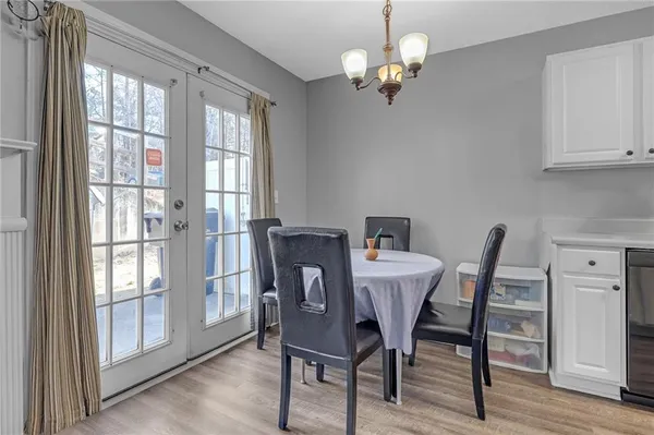 a view of a dining room with furniture wooden floor and chandelier