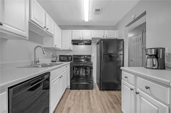 a kitchen with stainless steel appliances a refrigerator stove and sink