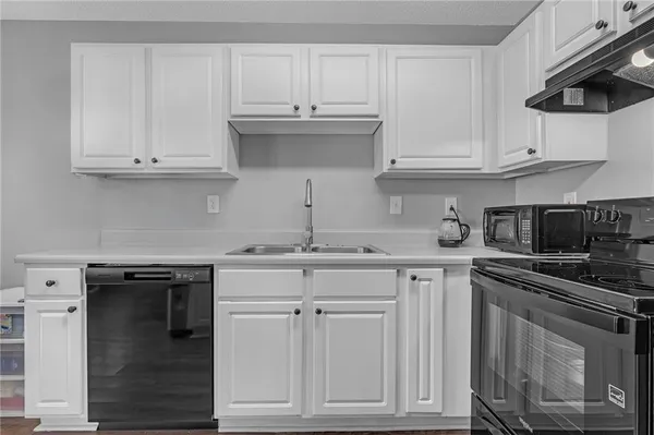 a kitchen with white cabinets and a stainless steel appliances