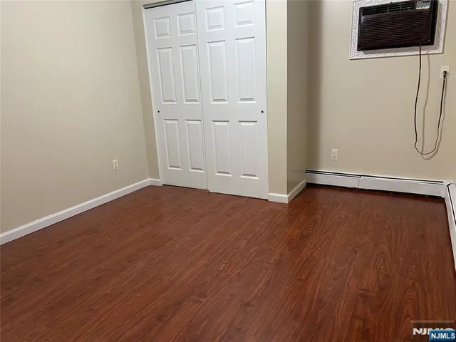 a view of a room with wooden floor and white wall