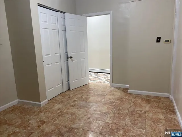 a view of room with hallway and closet