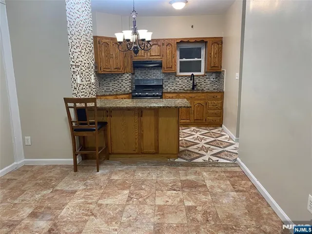 a bathroom with a granite countertop sink a mirror and a vanity
