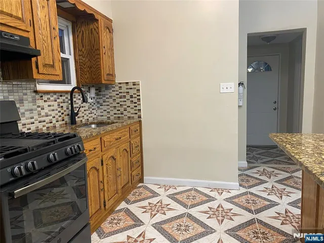 a kitchen with granite countertop a stove and a granite counter tops