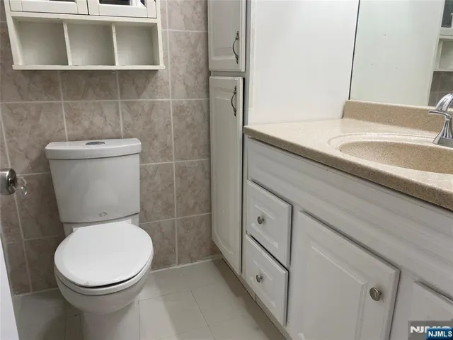 a white toilet sitting next to a bathroom sink