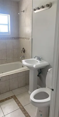 a bathroom with a sink a toilet and a bathtub