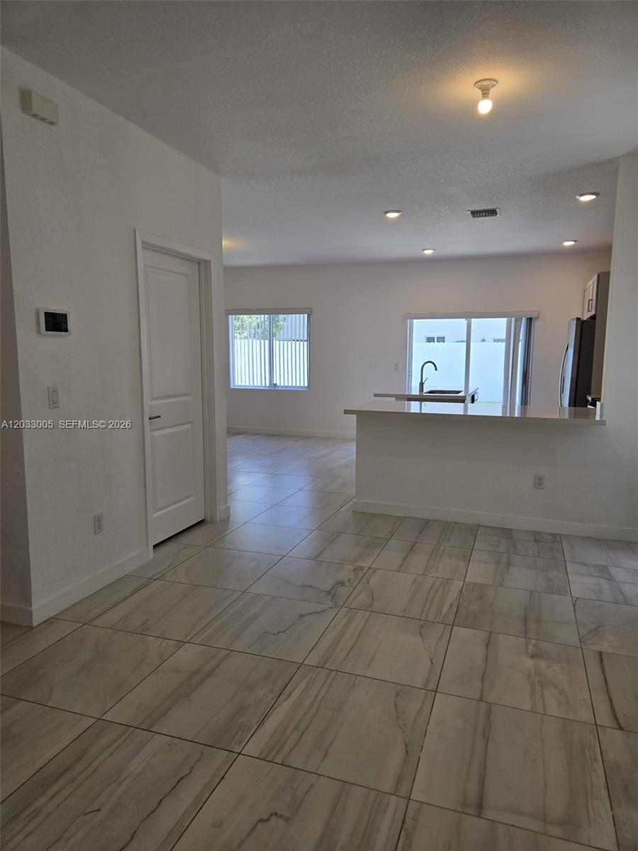 862 Southeast 17 Street, Unit 862 Homestead, FL 33034 - Photo 11 of 39 an empty room with windows and entrance