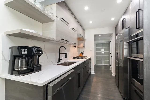 a kitchen with cabinets and stainless steel appliances
