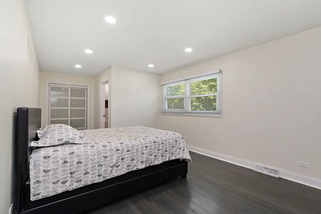 a bedroom with a large bed and a window